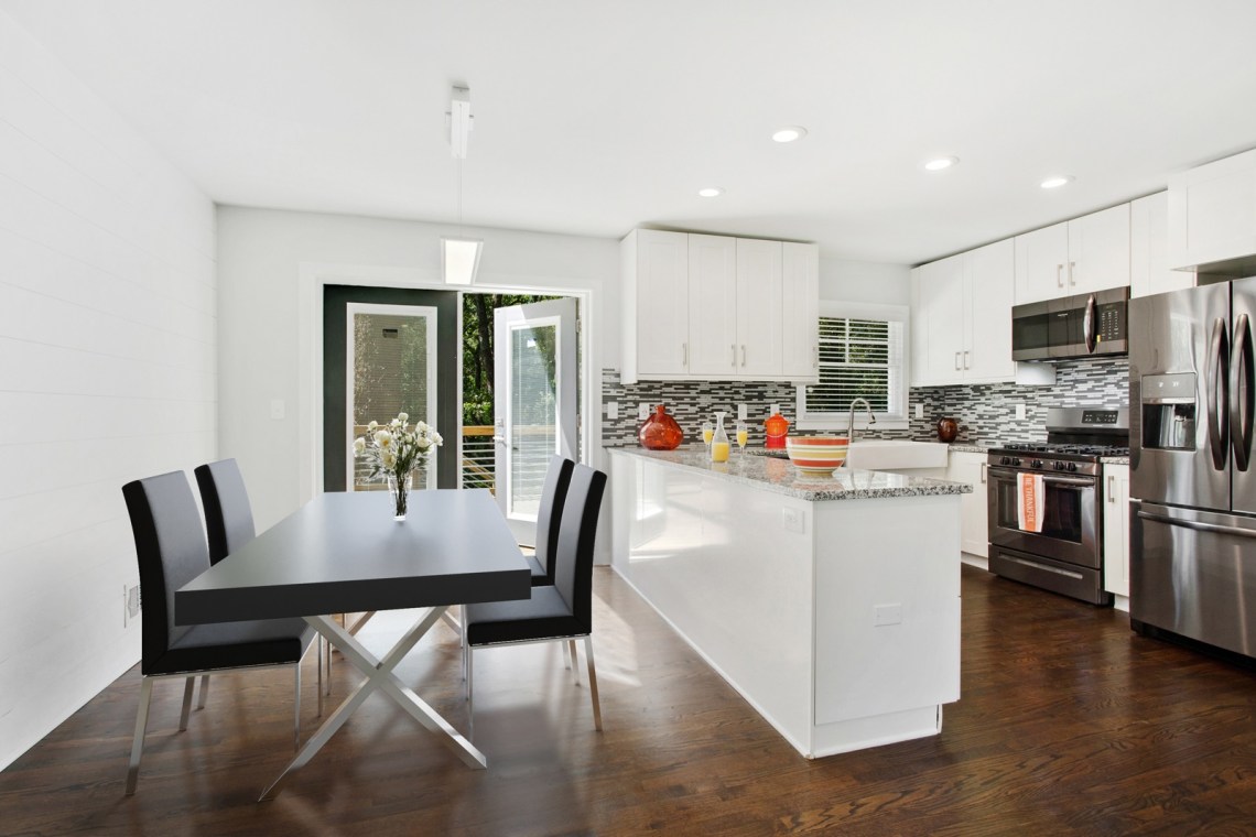 1staged dining room with kitchen view