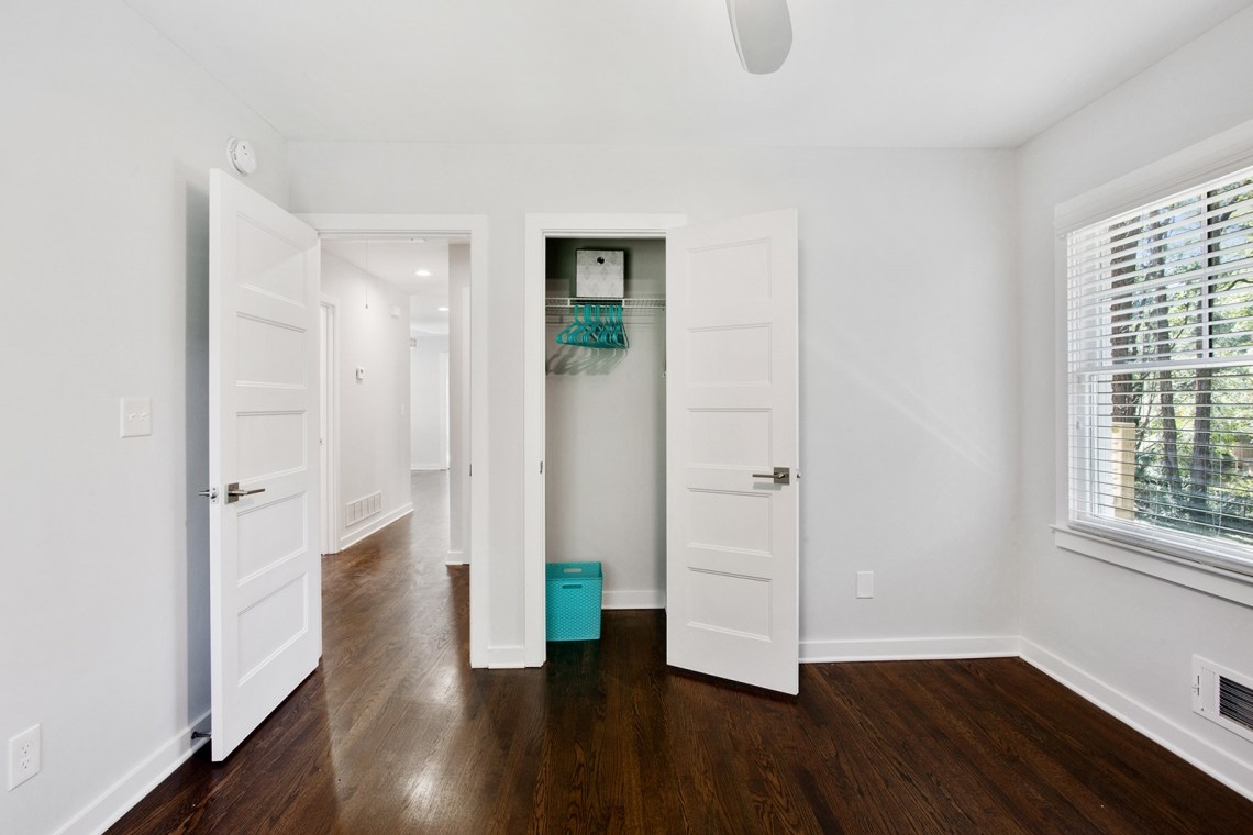 22 small bedroom showing closet open and view to hallway